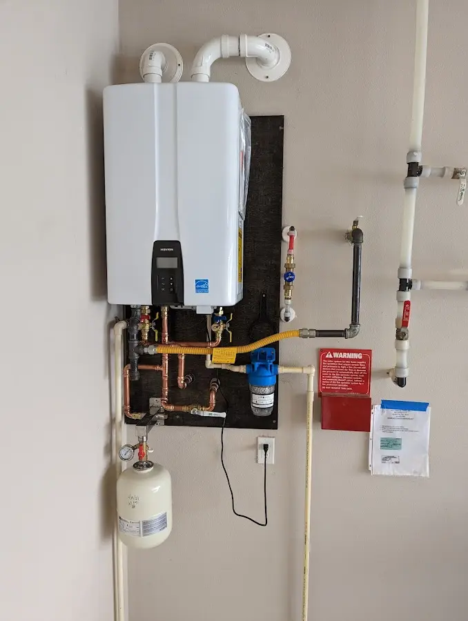 Professional plumber installing copper piping in a Kearney home